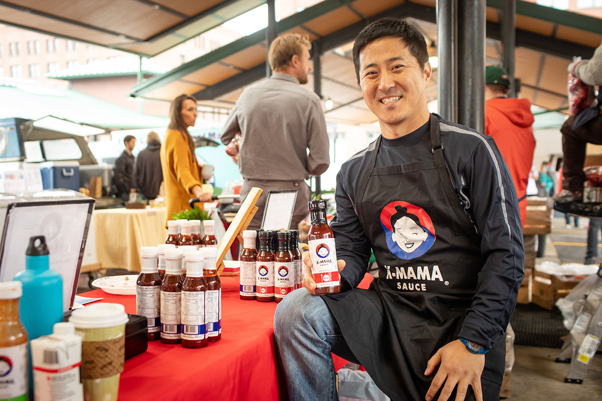 KC Kye, founder of k-mama sauce at a farmers market