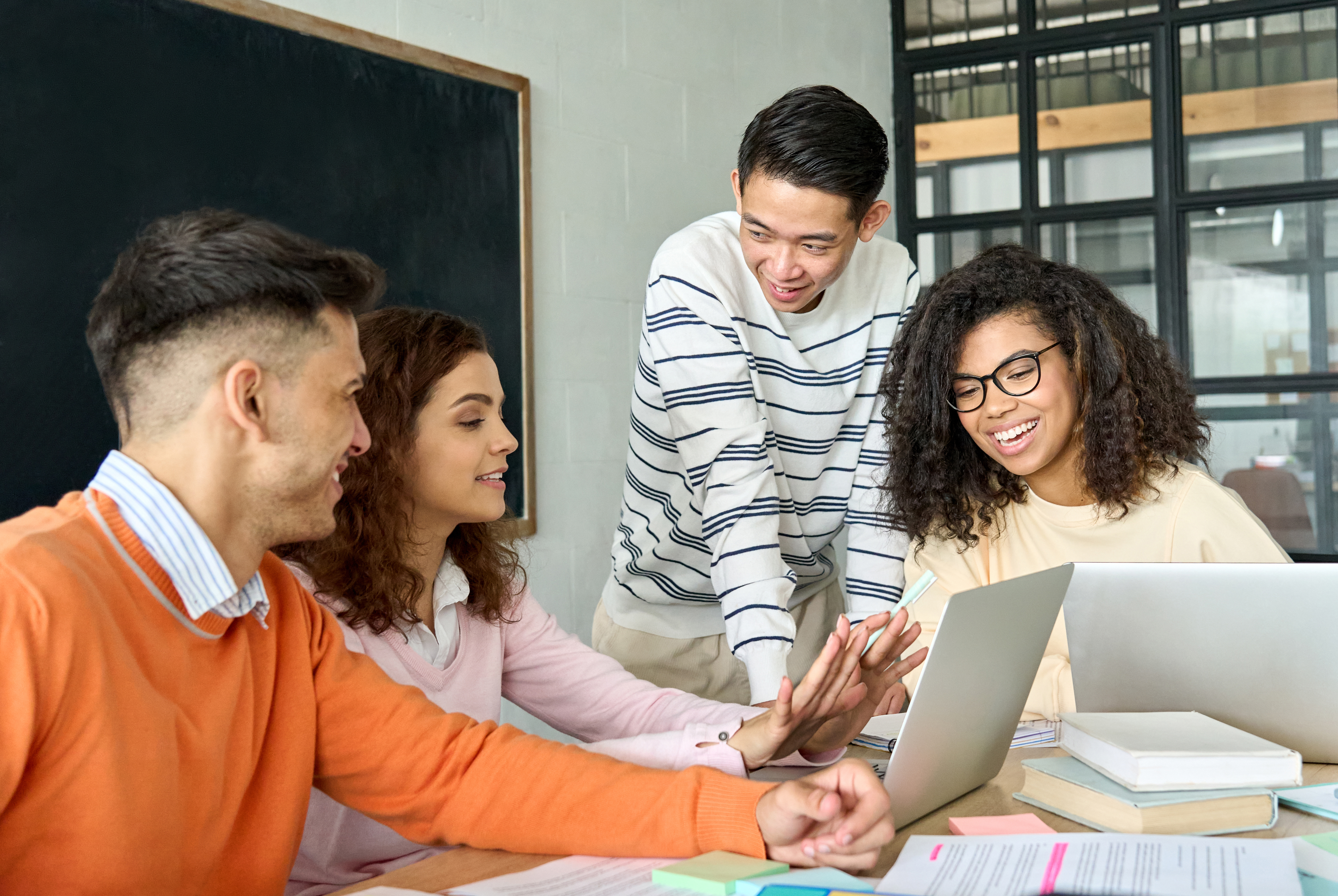Four multiethnic colleagues smiling during a discussion