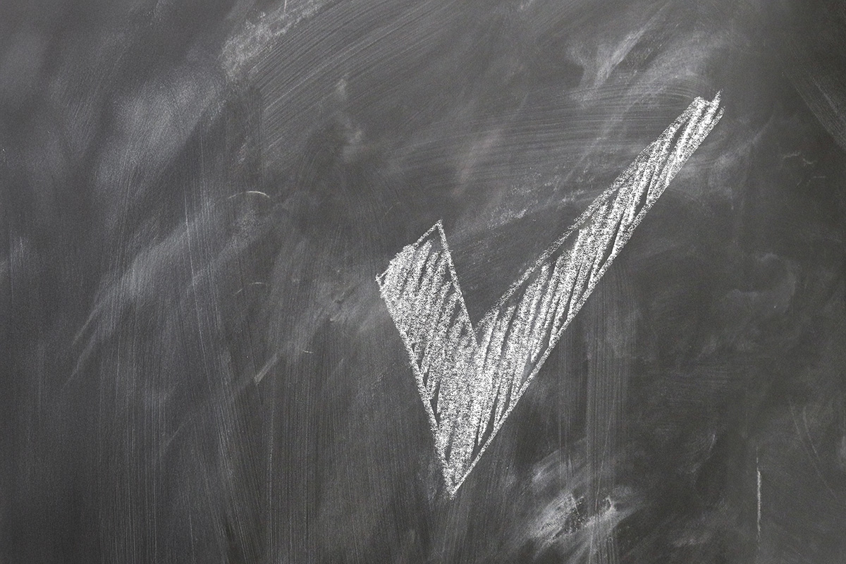 A checkmark on a blackboard. 