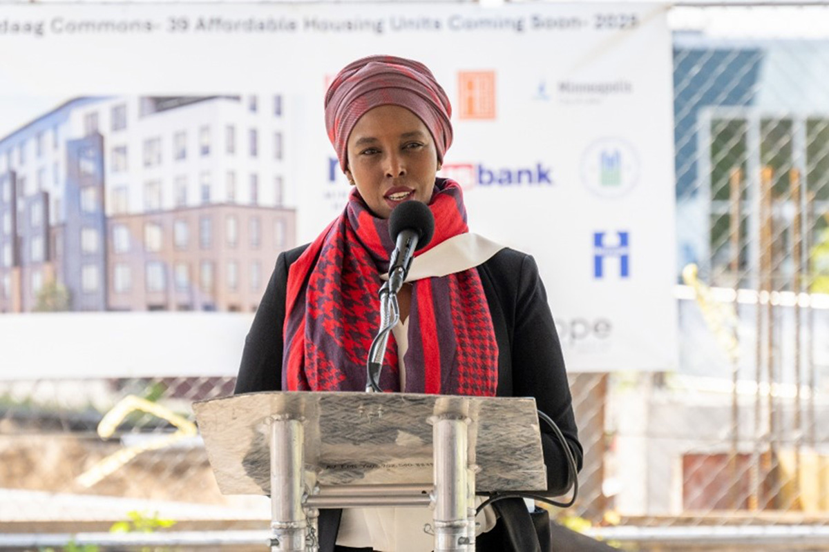 Nawal Noor speaking behind a podium. 