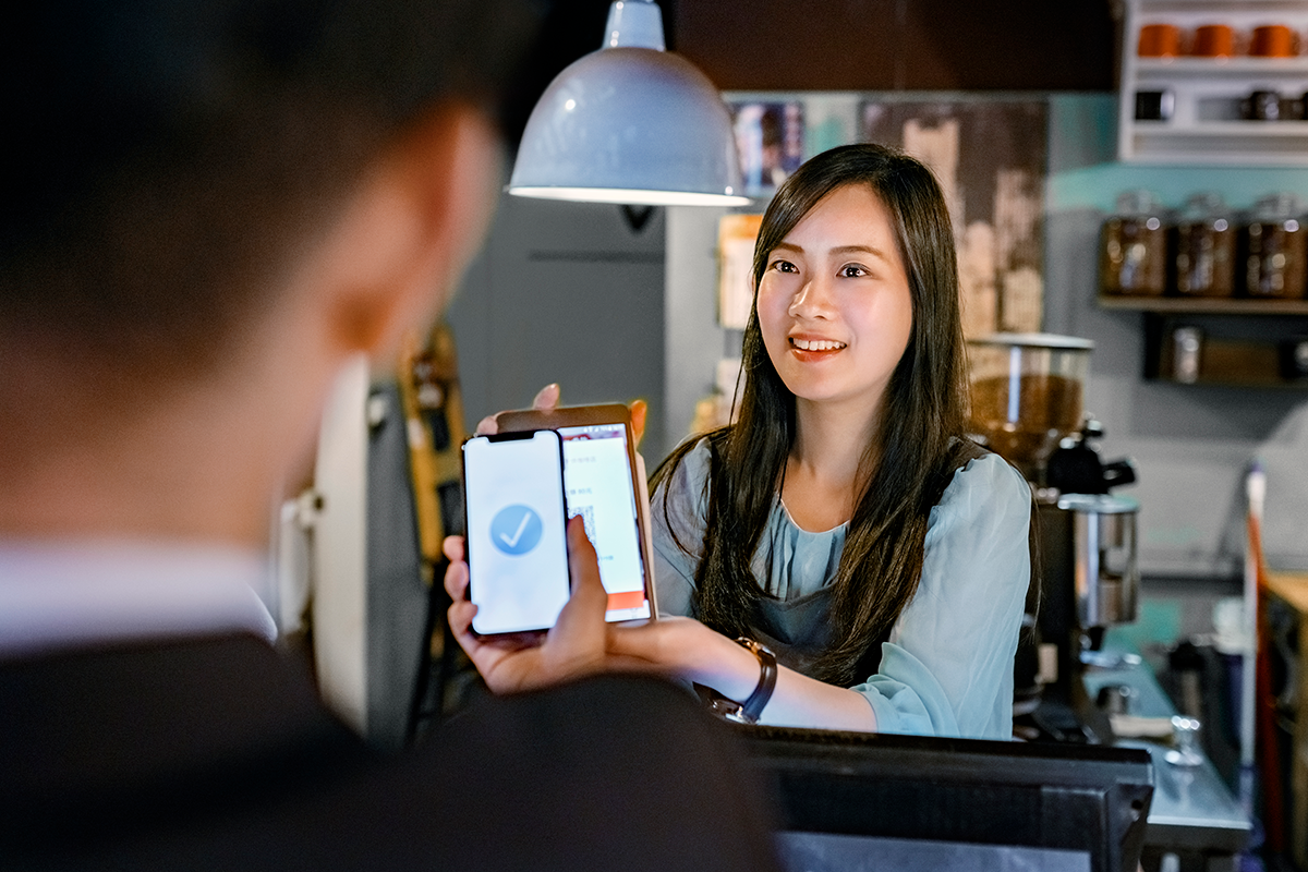 A woman business owner completing a transaction