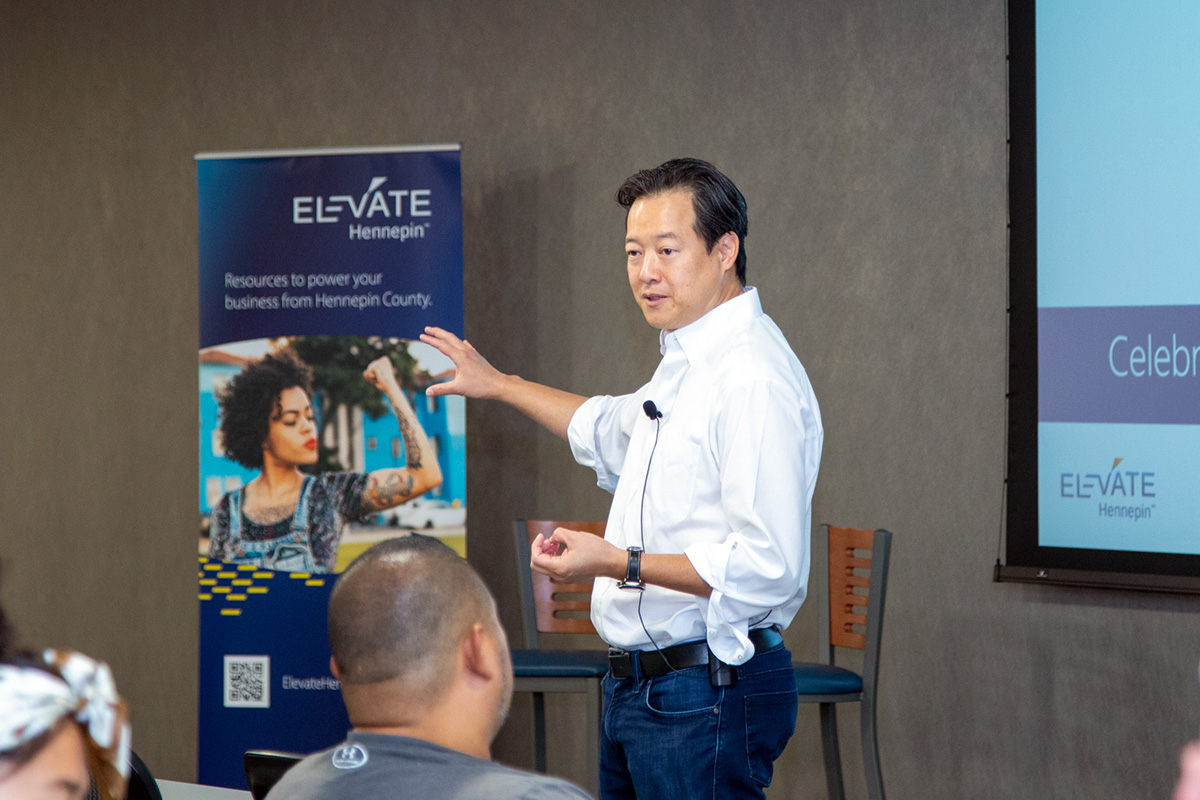 Victor Hwang of Right to Start discussing barriers to small business and entrepreneurs during a visit to Hennepin County with Elevate Hennepin staff. 